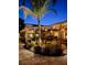 Landscaped backyard with a pool and patio at night at 318 Stone Castle Loop, Lady Lake, FL 32159