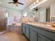 Bathroom boasts dual sinks, a soaking tub, and a walk-in shower at 318 Stone Castle Loop, Lady Lake, FL 32159