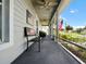 Relaxing screened porch with American flag decor and seating at 318 Stone Castle Loop, Lady Lake, FL 32159