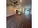 Open concept living room and kitchen with wood-look floors at 12202 Se 87Th Ct, Belleview, FL 34420