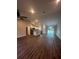 Open concept living room and kitchen with wood-look floors at 12202 Se 87Th Ct, Belleview, FL 34420