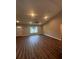 Living room with wood-look floors, high ceilings and ceiling fan at 12202 Se 87Th Ct, Belleview, FL 34420