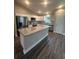 Kitchen with granite island, stainless steel appliances, and luxury vinyl plank flooring at 12202 Se 87Th Ct, Belleview, FL 34420