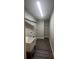 Bright laundry room with utility sink, shelving, and vinyl flooring at 12202 Se 87Th Ct, Belleview, FL 34420