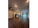 Open concept living room and kitchen with wood-look floors at 12202 Se 87Th Ct, Belleview, FL 34420