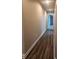 Hallway with wood flooring and access to garage at 12202 Se 87Th Ct, Belleview, FL 34420