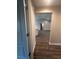 Bright hallway with wood flooring, leading to open living area at 12202 Se 87Th Ct, Belleview, FL 34420
