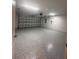 Spacious garage with epoxy flooring and an overhead door at 12202 Se 87Th Ct, Belleview, FL 34420