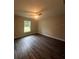 Spacious bedroom featuring wood-look floors and a window at 12202 Se 87Th Ct, Belleview, FL 34420