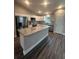 Kitchen with granite island, stainless steel appliances, and luxury vinyl plank flooring at 12202 Se 87Th Ct, Belleview, FL 34420