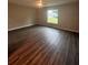Spacious bedroom featuring wood-look flooring and a ceiling fan at 12202 Se 87Th Ct, Belleview, FL 34420
