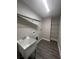 Laundry room featuring a sink, shelving and vinyl flooring at 12202 Se 87Th Ct, Belleview, FL 34420