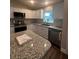 Modern kitchen with stainless steel appliances and granite countertops at 12202 Se 87Th Ct, Belleview, FL 34420