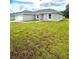 Newly constructed home with gray siding and a grassy lawn at 12202 Se 87Th Ct, Belleview, FL 34420