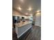 Kitchen with granite island, stainless steel appliances, and luxury vinyl plank flooring at 12202 Se 87Th Ct, Belleview, FL 34420