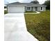 Newly built single story house with a two-car garage and driveway at 12202 Se 87Th Ct, Belleview, FL 34420