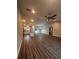 Open concept living room and kitchen with wood-look floors at 12202 Se 87Th Ct, Belleview, FL 34420