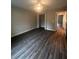 Large bedroom with wood-look floors and a walk-in closet at 12202 Se 87Th Ct, Belleview, FL 34420