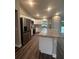 Kitchen with granite island, stainless steel appliances, and luxury vinyl plank flooring at 12202 Se 87Th Ct, Belleview, FL 34420