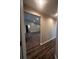 Bright hallway with wood flooring, leading to open living area at 12202 Se 87Th Ct, Belleview, FL 34420