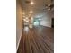 Open concept living room and kitchen with wood-look floors at 12202 Se 87Th Ct, Belleview, FL 34420