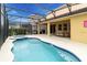 Relaxing pool and spa area with covered patio and lush landscaping at 6047 Broad Oak Dr, Davenport, FL 33837