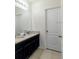 Clean bathroom with granite countertop and dark wood cabinets at 6047 Broad Oak Dr, Davenport, FL 33837