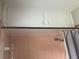 Bathroom with pink tile and overhead storage at 1639 Silver Star Rd, Orlando, FL 32804
