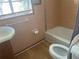 Bathroom with pink tile, shower/tub combo, and toilet at 1639 Silver Star Rd, Orlando, FL 32804