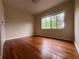 Bedroom featuring hardwood floors and a large window at 1639 Silver Star Rd, Orlando, FL 32804
