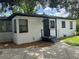 Rear view of a white house with black trim and landscaping at 1639 Silver Star Rd, Orlando, FL 32804
