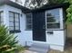 Front view of a charming bungalow with black door at 1639 Silver Star Rd, Orlando, FL 32804