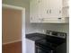Kitchen with white cabinets, granite counters, and black appliances at 1639 Silver Star Rd, Orlando, FL 32804