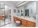 Double vanity bathroom with a large shower and mirrored closet doors at 1013 Nin St, Orlando, FL 32835