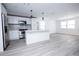 Modern kitchen featuring white shaker cabinets, stainless steel appliances, and a large island at 2070 W Airport Blvd, Sanford, FL 32771