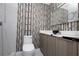Modern bathroom with birch wallpaper and updated fixtures at 2070 W Airport Blvd, Sanford, FL 32771