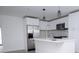 Modern kitchen with white cabinets, island, & stainless steel appliances at 2070 W Airport Blvd, Sanford, FL 32771