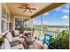 Screened balcony overlooking a lake with comfy seating at 1905 Sanderling Dr, Clermont, FL 34711