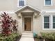 Townhouse entrance with brown door and landscaping at 3561 Clay Brick Rd # 47A, Harmony, FL 34773