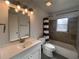 Updated bathroom with a white vanity and a bathtub at 7609 Rose Ave, Orlando, FL 32810
