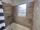Clean bathroom with tile shower and tub at 7609 Rose Ave, Orlando, FL 32810