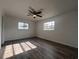 Spacious bedroom with wood-look flooring and ceiling fan at 7609 Rose Ave, Orlando, FL 32810