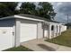 Newly painted home with a garage and arched entryway at 7609 Rose Ave, Orlando, FL 32810