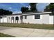 Newly painted home with a garage and arched entryway at 7609 Rose Ave, Orlando, FL 32810