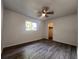 Bright bedroom with wood-look flooring and a walk-in closet at 7609 Rose Ave, Orlando, FL 32810