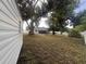 Spacious backyard with mature trees and a large grassy area at 7609 Rose Ave, Orlando, FL 32810