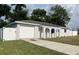 Newly renovated home with a white fence and a spacious driveway at 7609 Rose Ave, Orlando, FL 32810