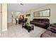 Open concept living area with leather seating and dining area view at 4527 Alberto Cir, Kissimmee, FL 34746