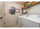 Laundry room with washer, dryer, and storage shelves at 4527 Alberto Cir, Kissimmee, FL 34746