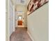 Hallway with carpet and large framed artwork at 4527 Alberto Cir, Kissimmee, FL 34746
